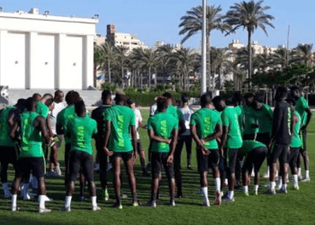 Super Eagles hopeful presents jersey to Buhari in Portugal