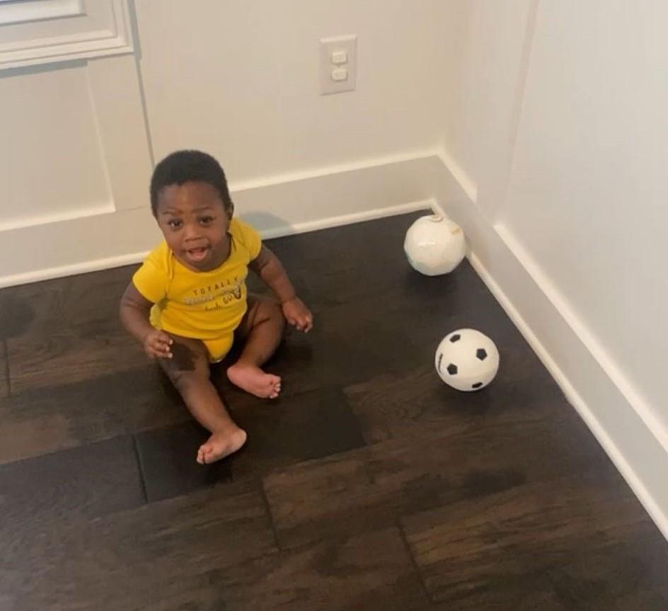 Tobenna at 8-months-old, a lover of the game.