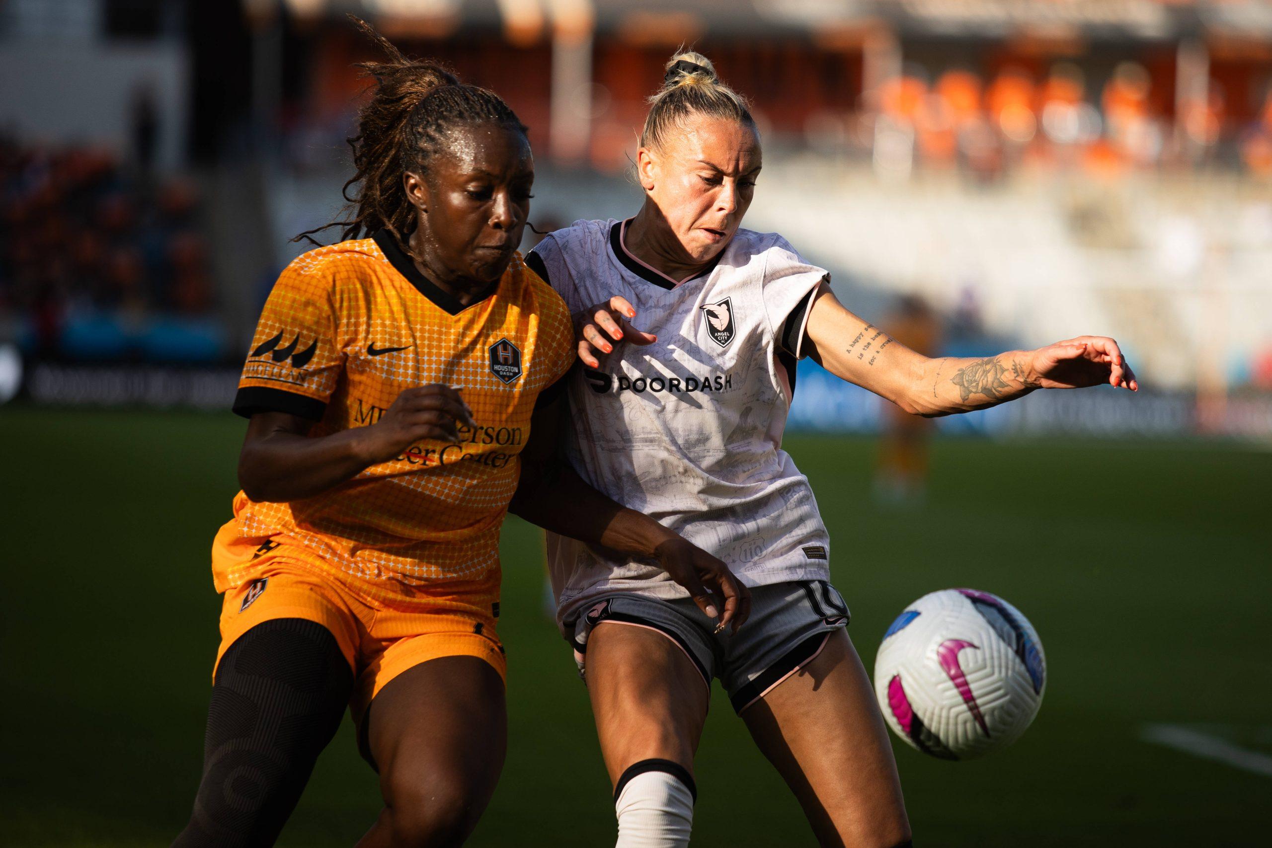 NWSL Houston Dash defender Michelle Alozie and Angel City FC defender M.A. Vignola battle for the ball during a match