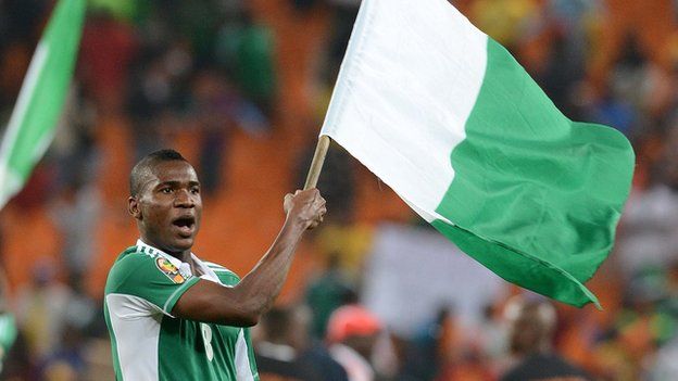 Ideye hoisting the Nigerian national flag after he won the 2013 edition of the AFCON tournament