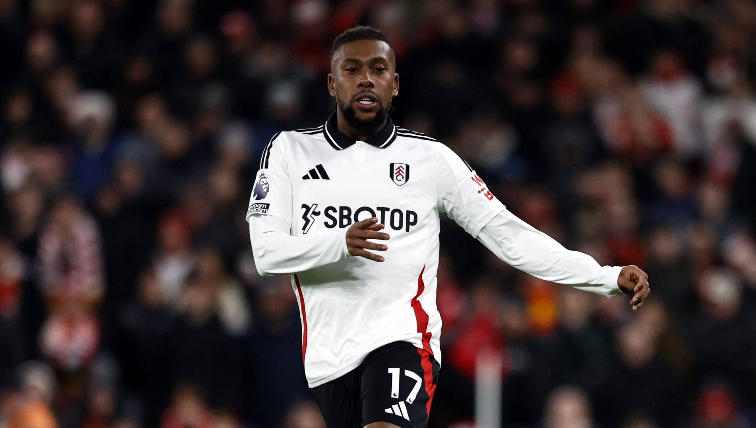Alex Iwobi in action for Fulham against Liverpool.