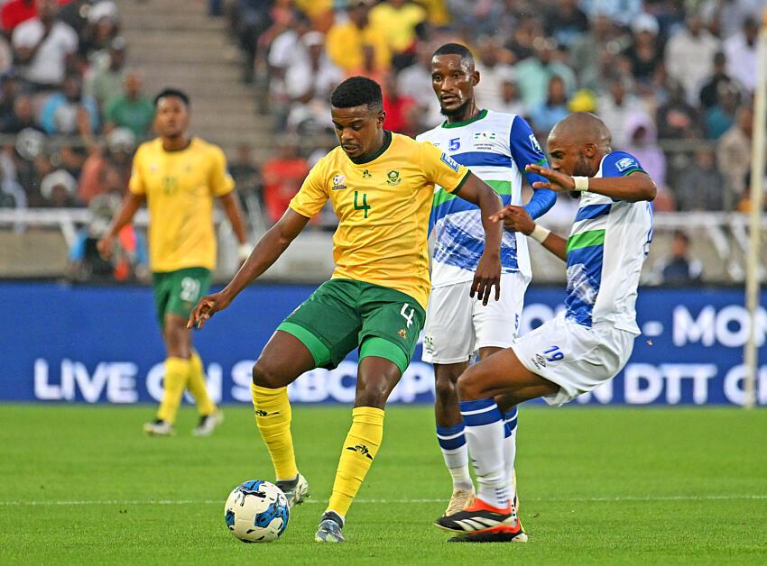 Teboho Mokoena of South Africa is challenged by Lehlohonolo Matsau of Lesotho