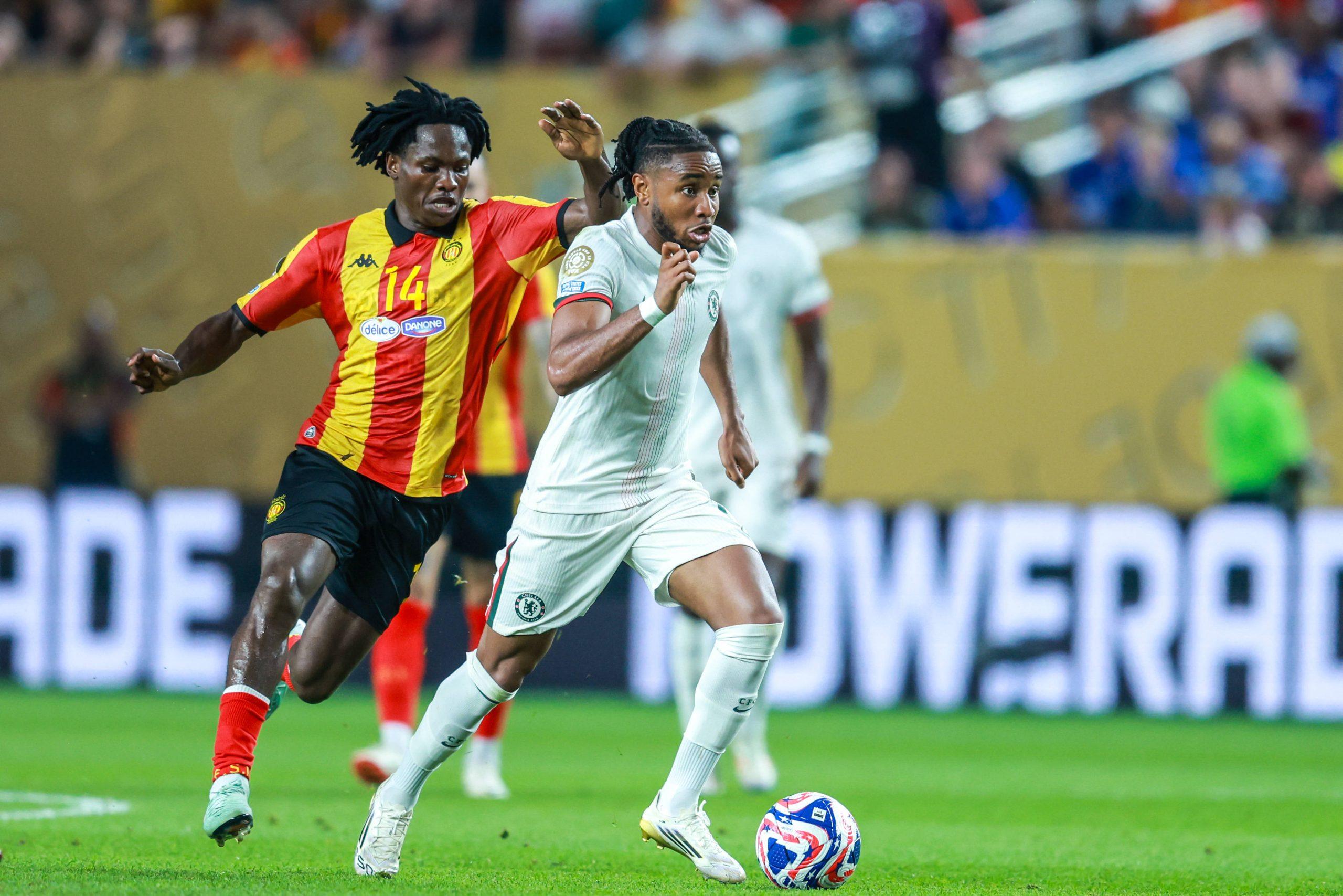 Onuche Ogbelu of Esperance De Tunisie battles for possession with 18 Christopher Nkunku of Chelsea