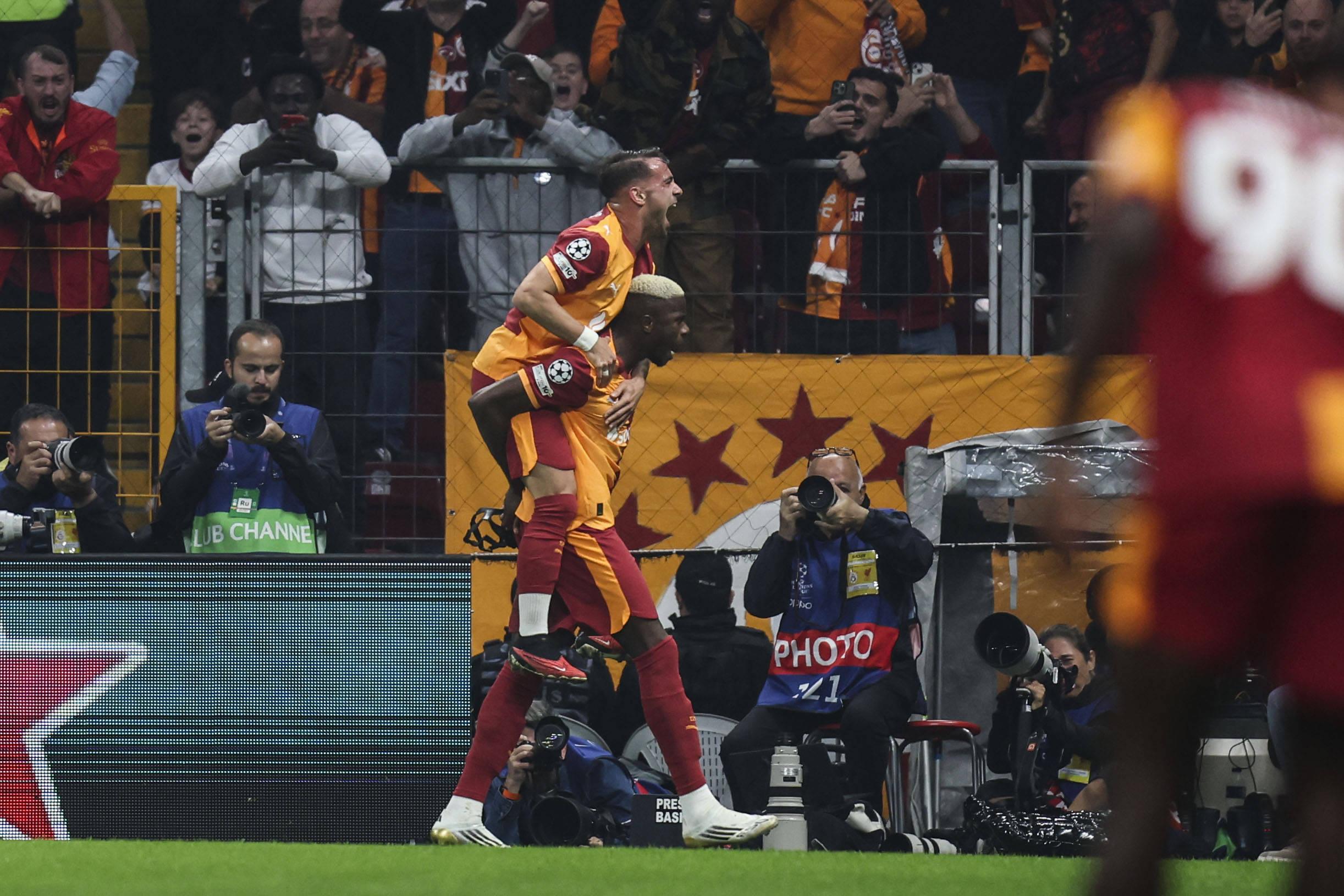 Victor Osimhen celebrates his goal with teammate Yunus Akgun during group phase match between Galatasaray and Liverpool in Istanbul