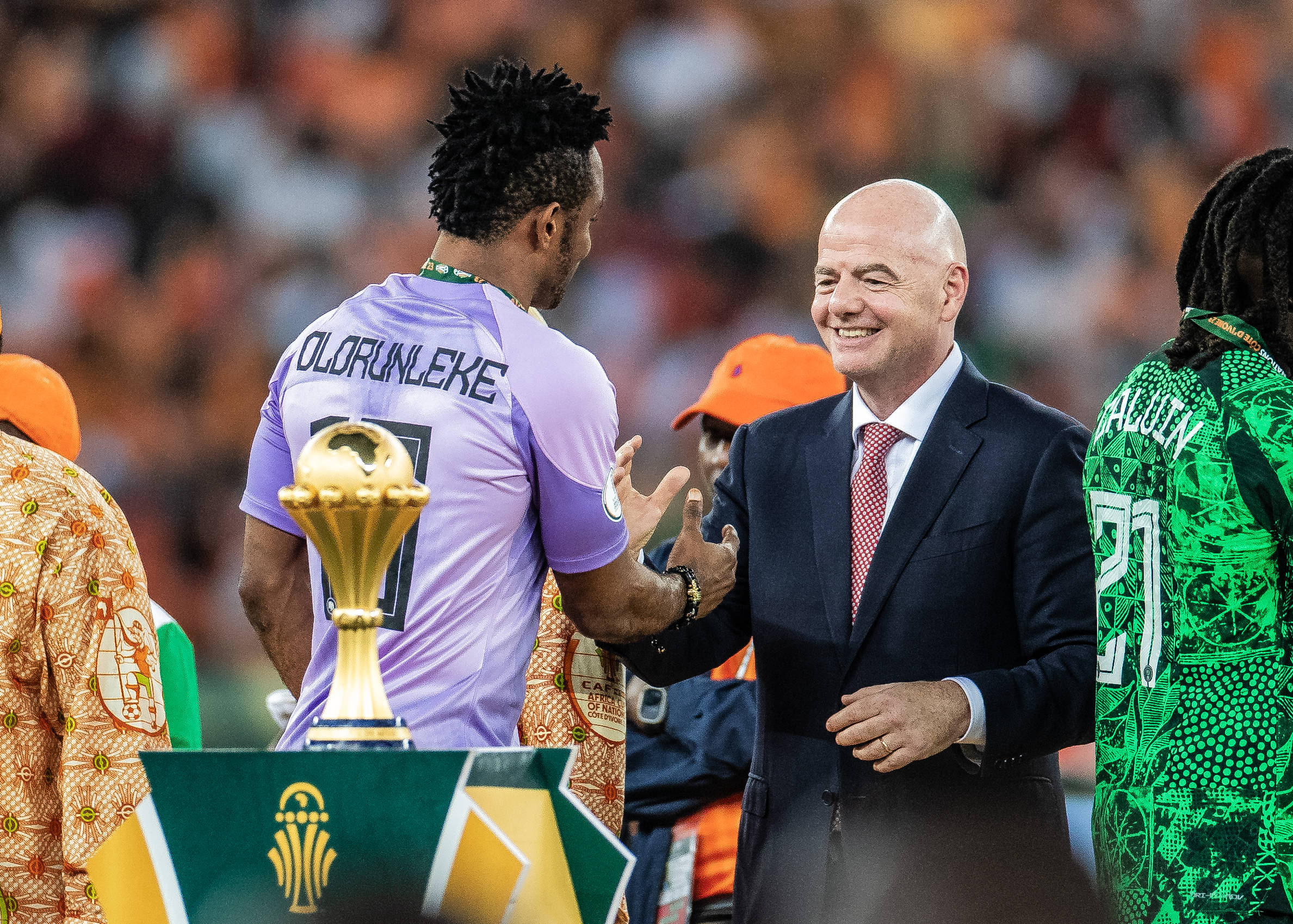 Nigeria's Olorunleke Ojo shaking FIFA President Gianni Infantino