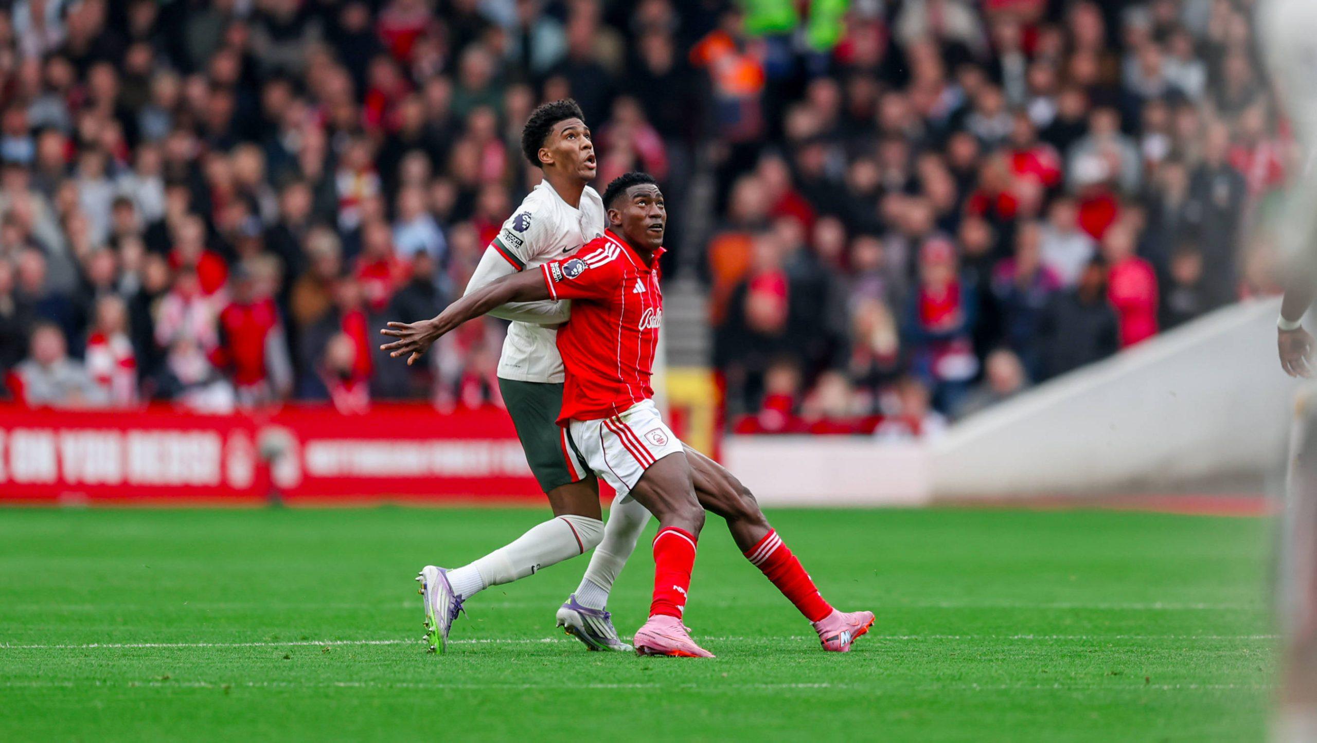 Josh Acheampong challenges forward Taiwo Awoniyi during the Premier League match between Nottingham Forest and Chelsea