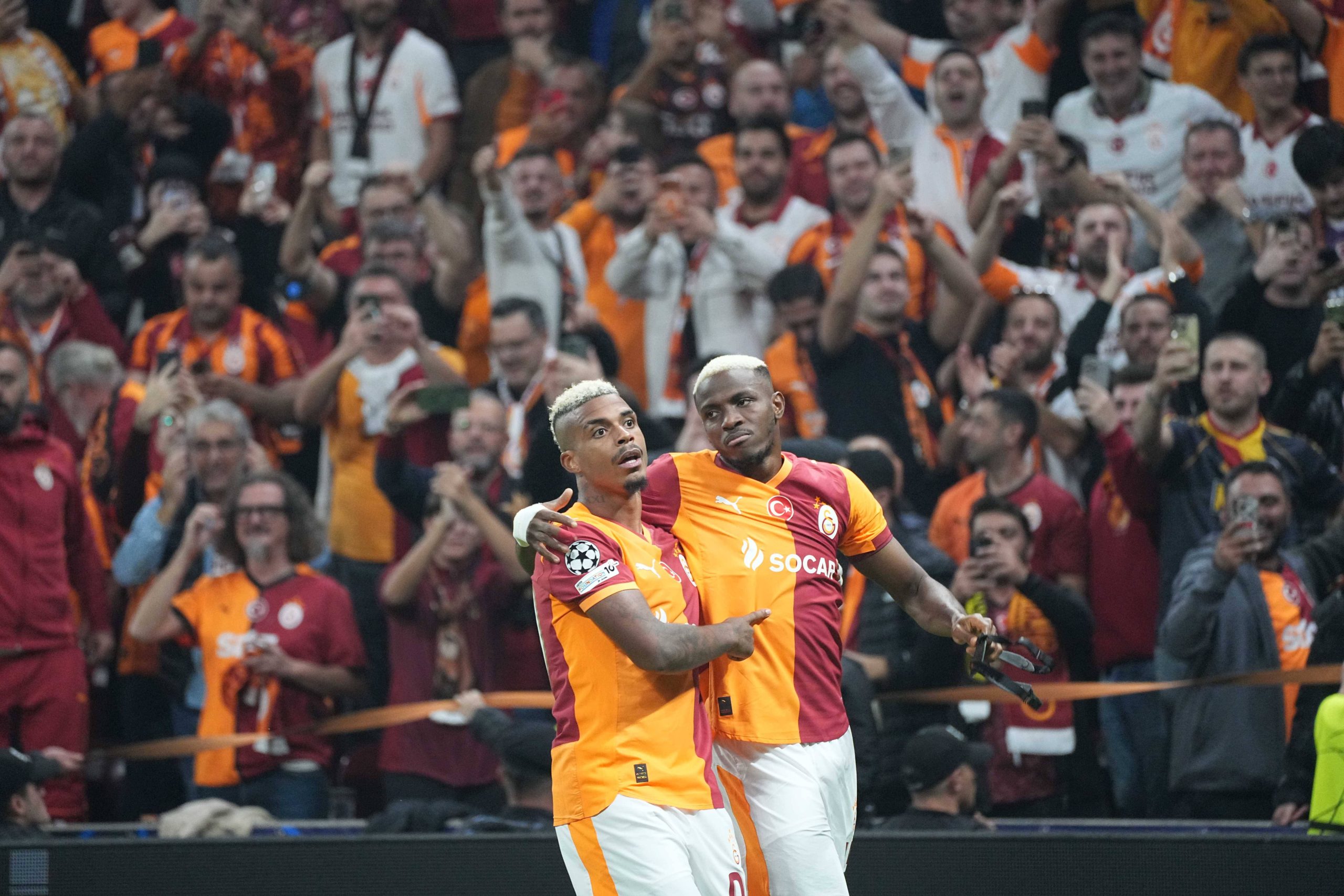 Victor Osimhen celebrates his goal with teammate Mario Lemina during the UEFA Champions League league phase match between Galatasaray SK and FK Bodo/Glimt in Istanbul, Turkey