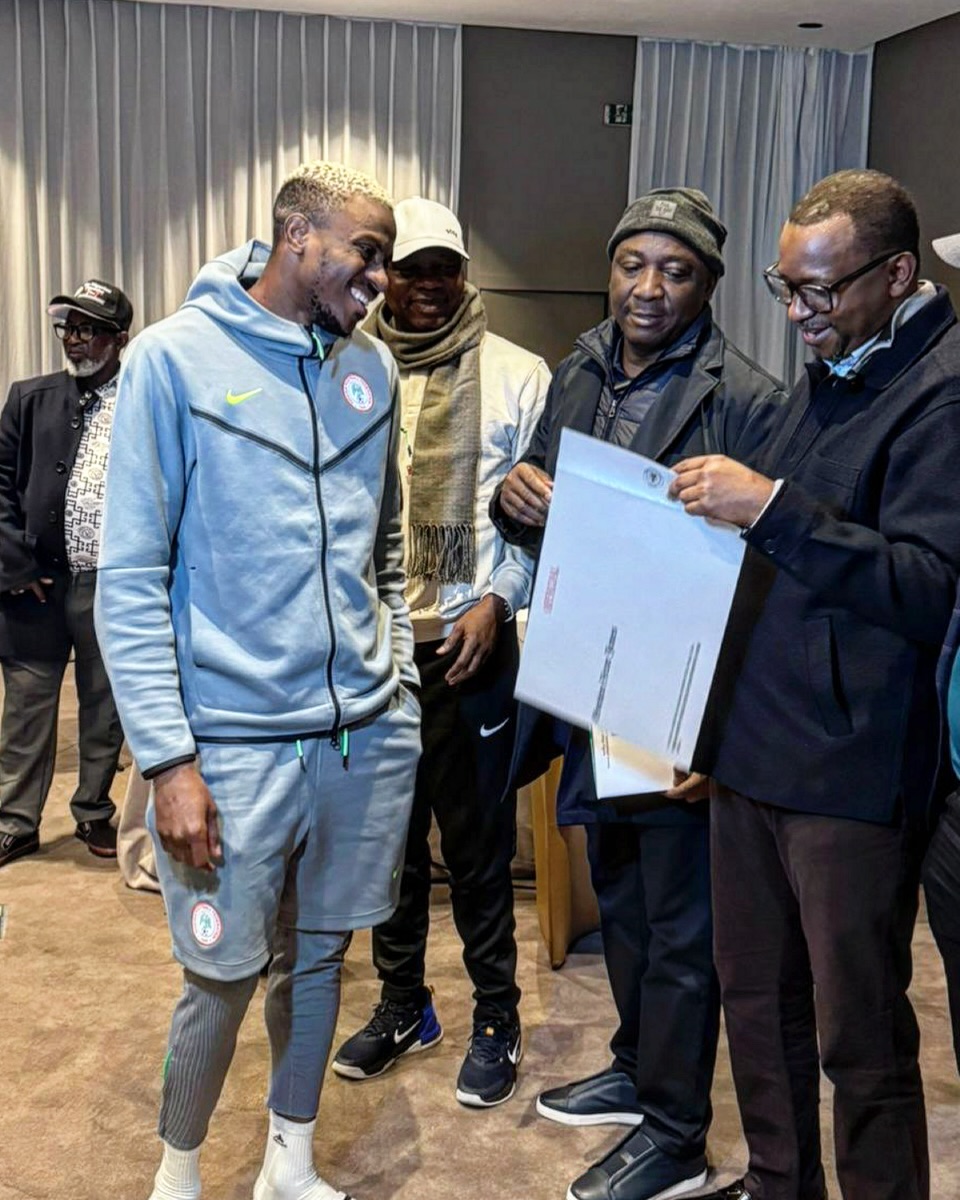 Super Eagles star Alex Iwobi receiving the document to his property