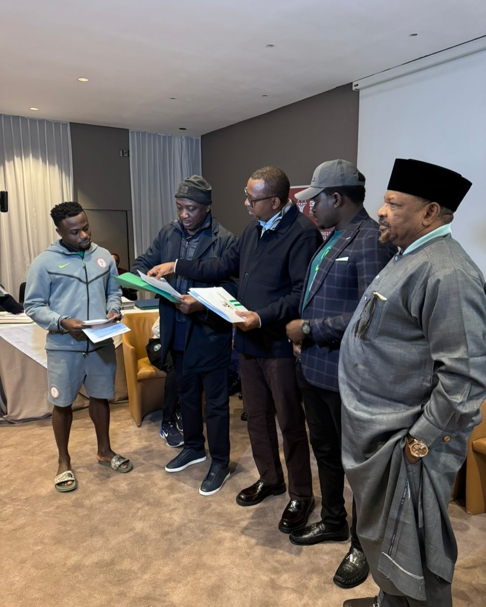 Super Eagles star Moses Simon receiving the document to his property