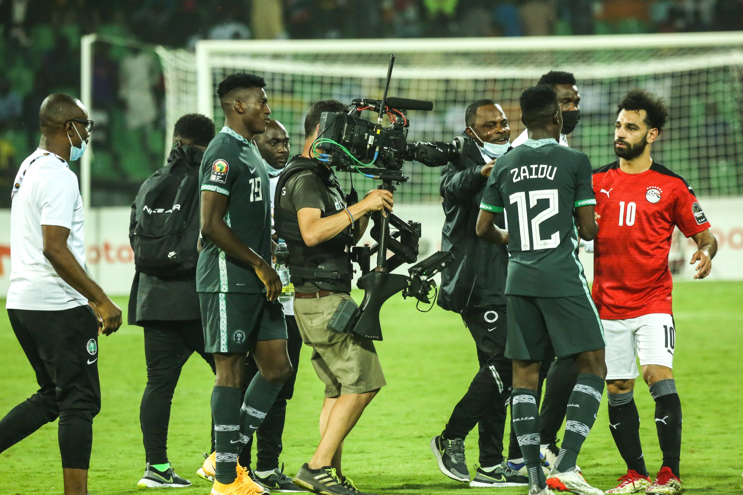Nigeria celebrate with Mohamed Salah after final whistle during the 2021 Africa Cup Of Nations match between Nigeria and Egypt