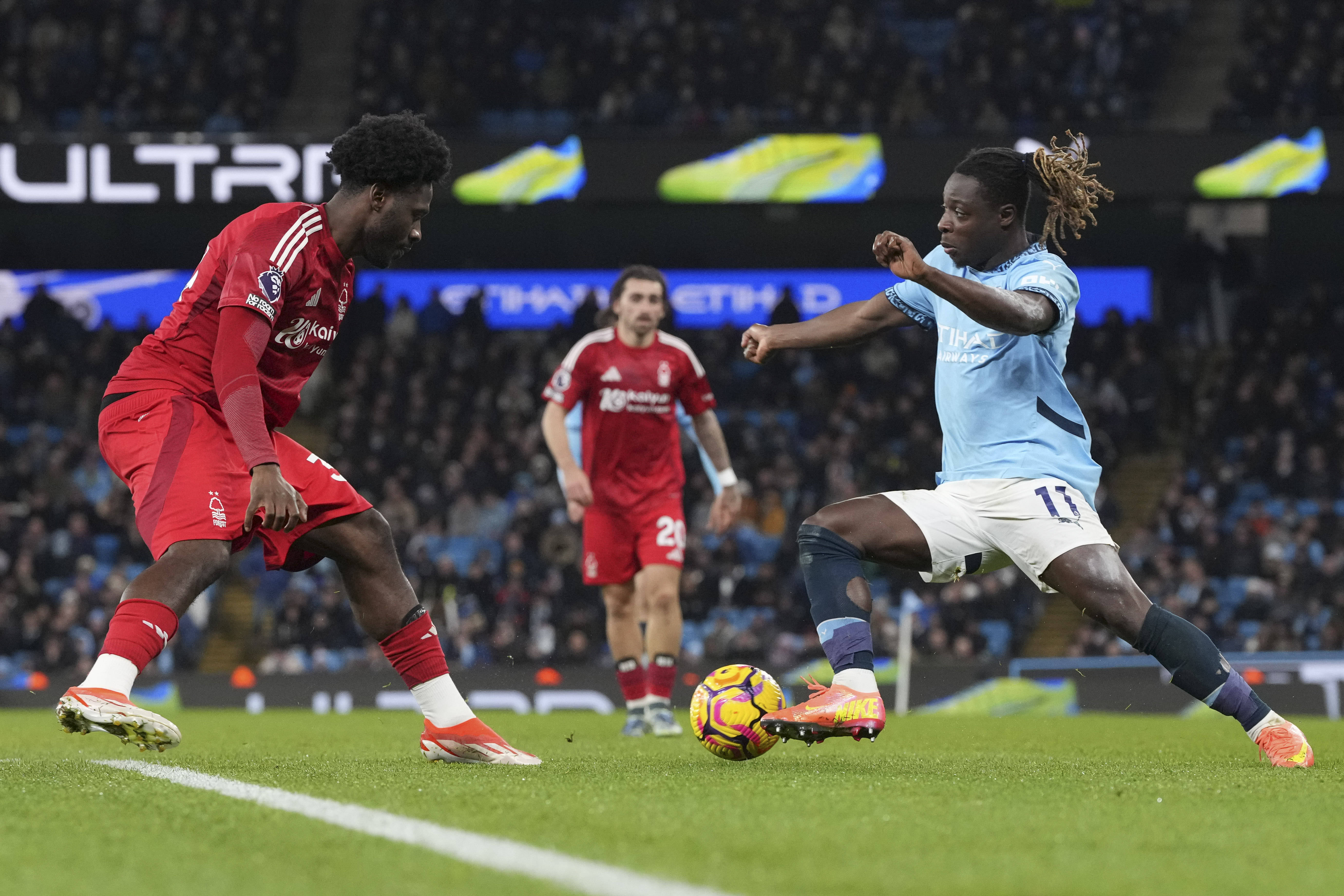 Jeremy Doku runs at Ola Aina