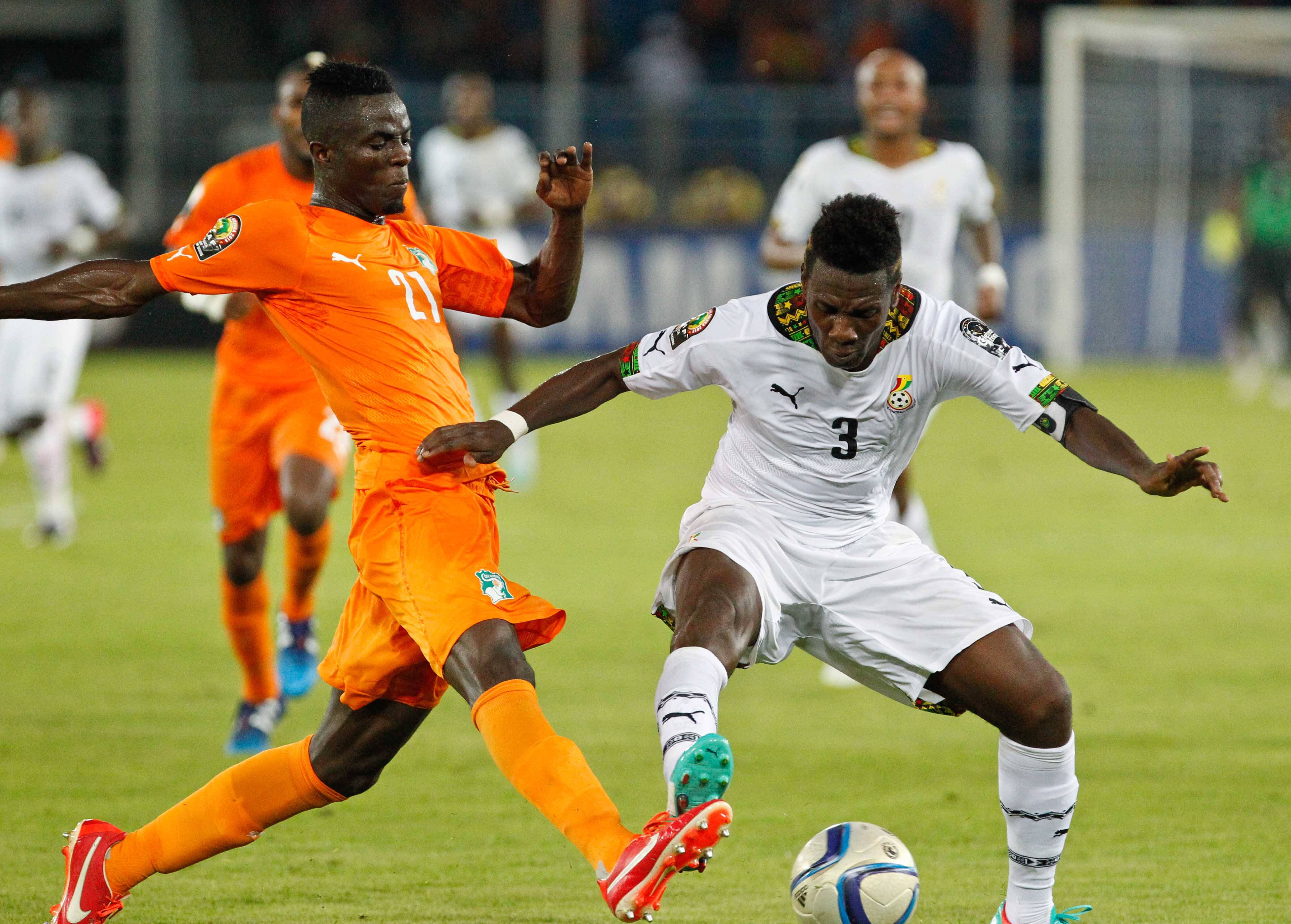 Asamoah Gyan vies with Eric Bertrand Bailly during the final match of Africa Cup of Nations