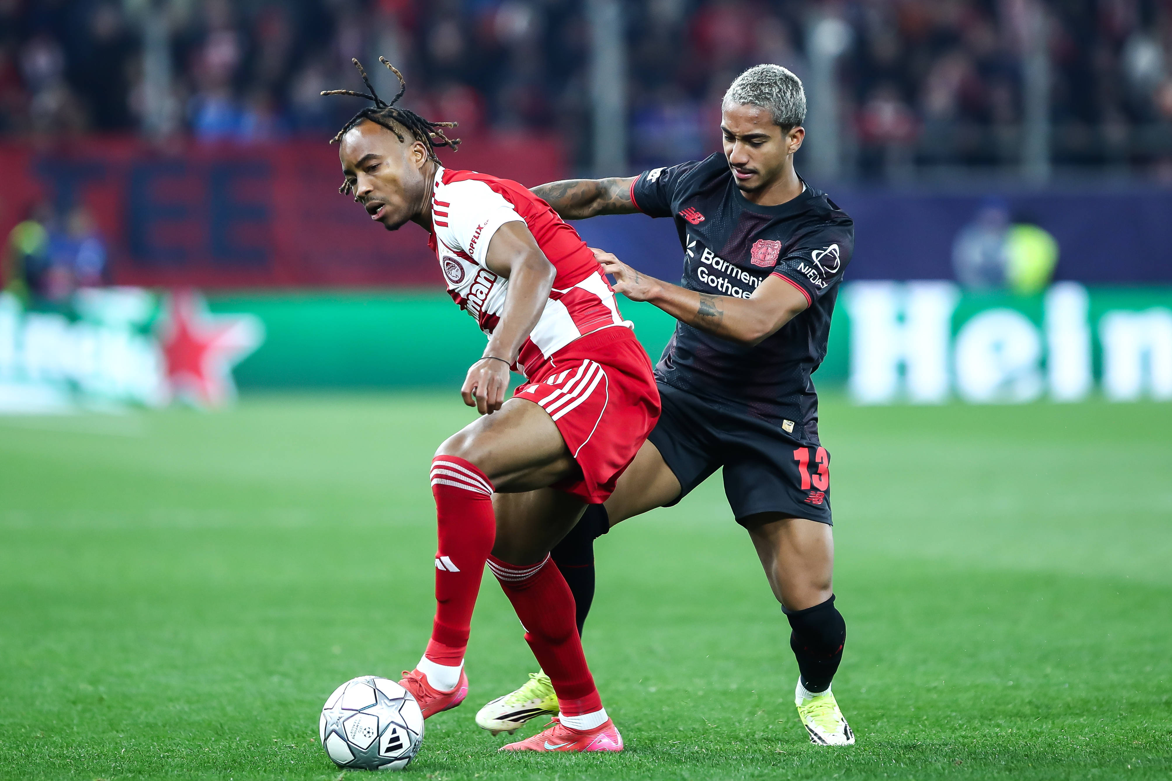 Arthur of Bayer 04 Leverkusen competes with Bruno Onyemaechi of Olympiacos