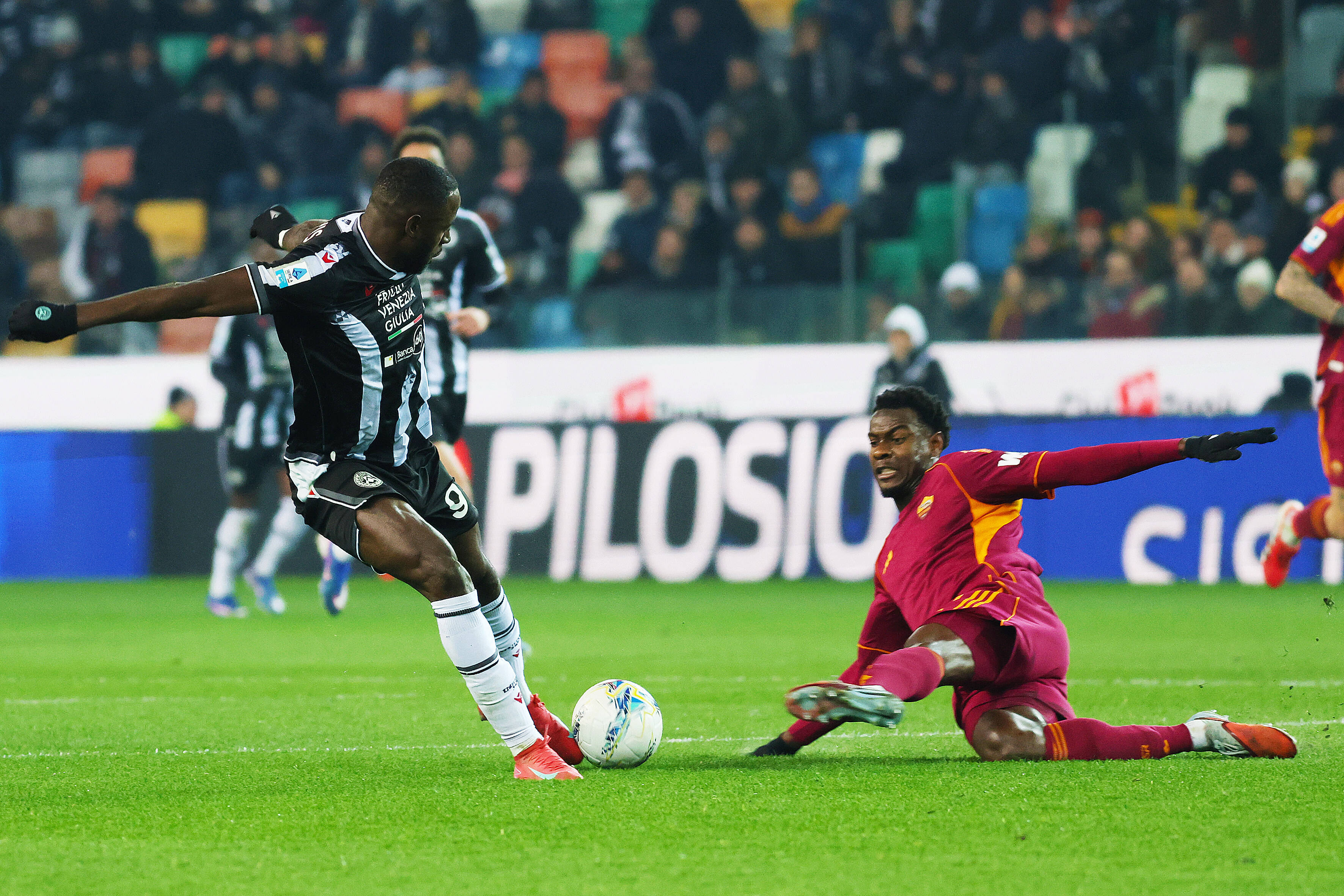 Udinese s Keinan Davis fights for the ball with Romas Evan Ndicka during the Serie A soccer match between Udinese and Roma