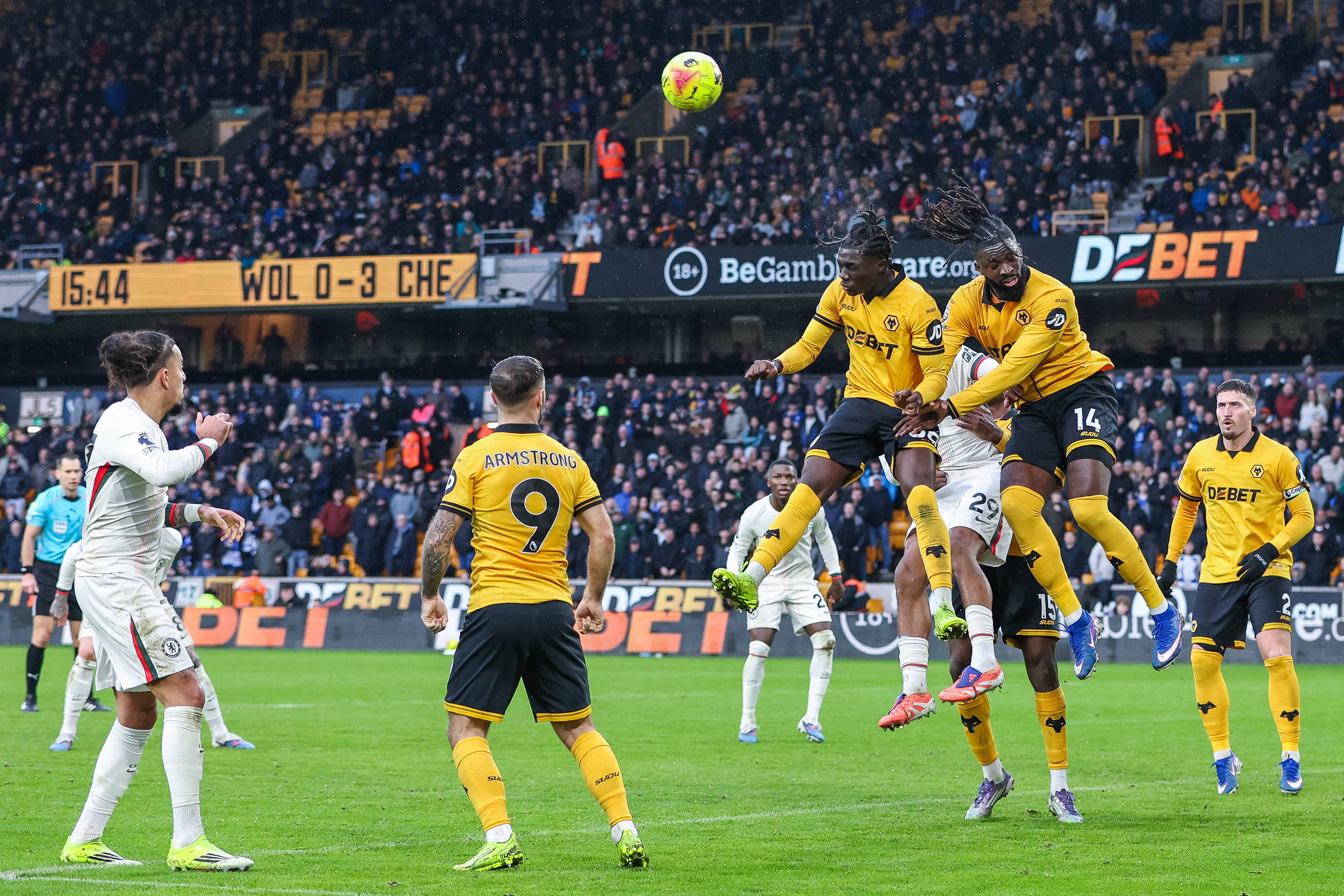 Mateus Mane and Tolu Arokodare beat Wesley Fofana in the air to head the ball during the Premier League match between Wolverhampton Wanderers and Chelsea