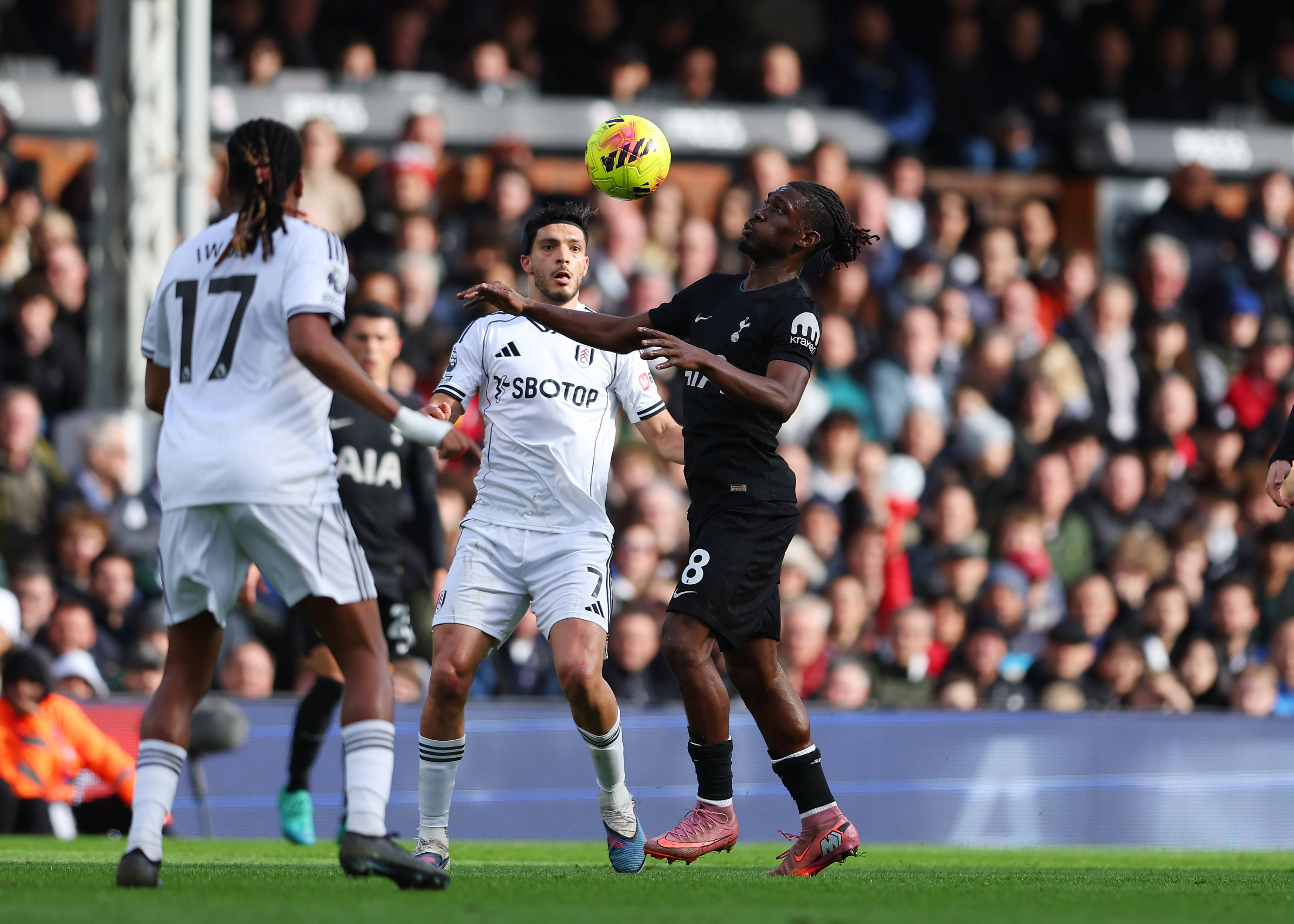 Yves Bissouma closely marked by Alex Iwobi