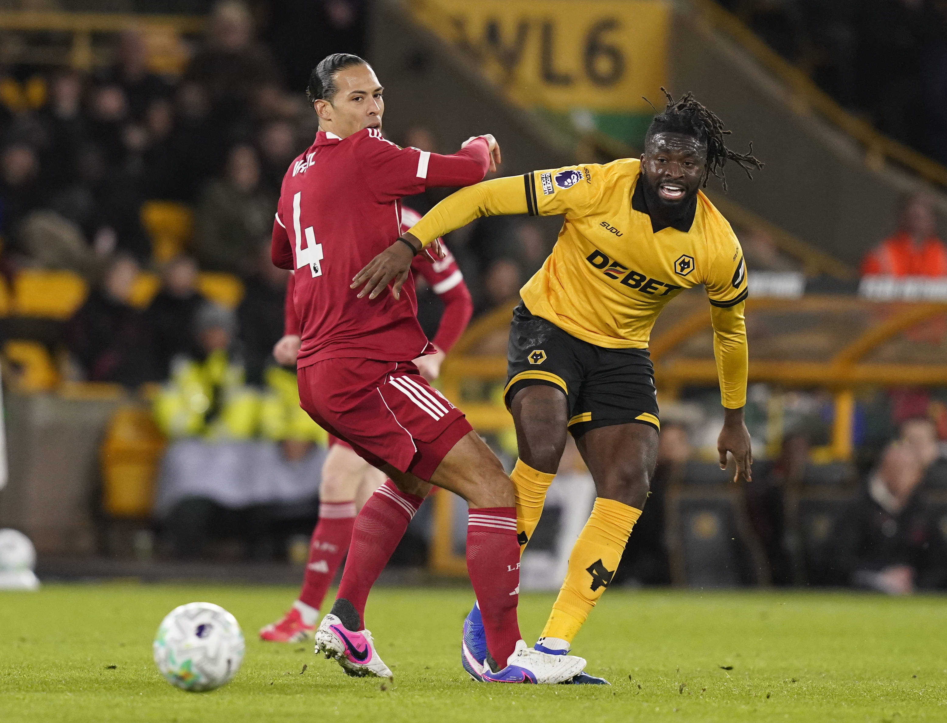 Virgil van Dijk of Liverpool turned by Tolu Arokodare of Wolverhampton Wanderers
